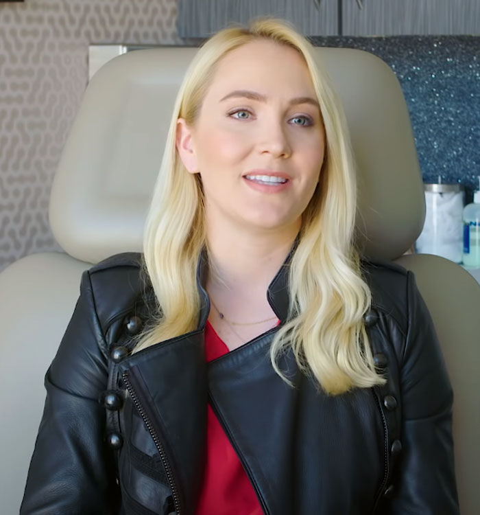 A female patient with blonde hair for ear surgery sitting in Dr Dhir's office